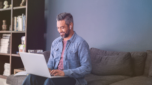 Happy man working from home (1152 x 649 px)