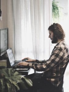 Man typing during a virtual meeting
