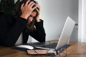 Frustrated woman working on her laptop